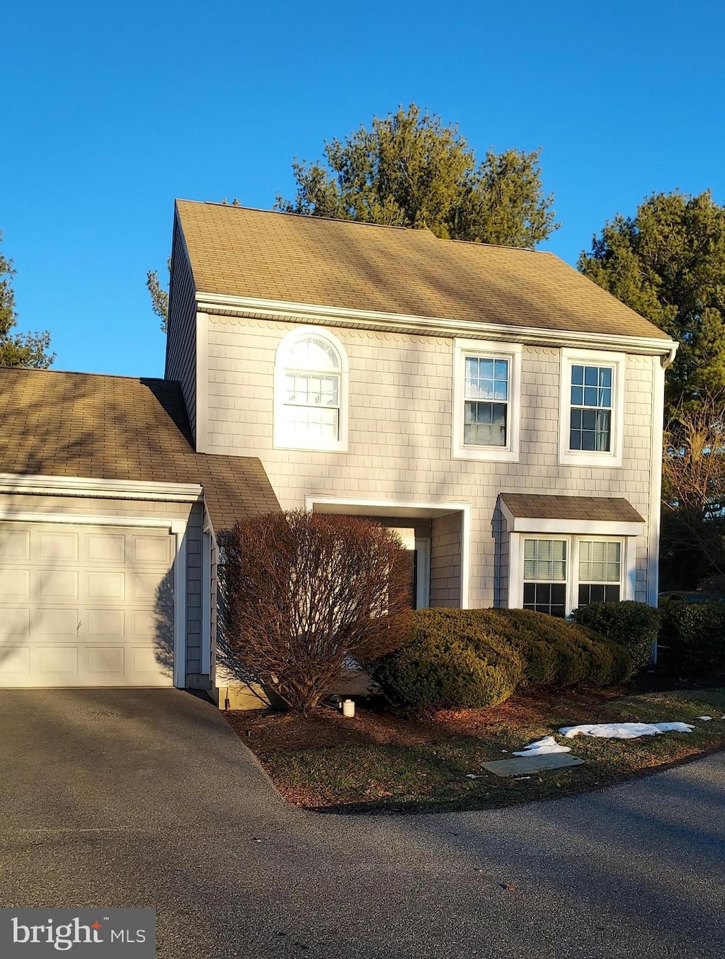 colonial inspired home with a garage