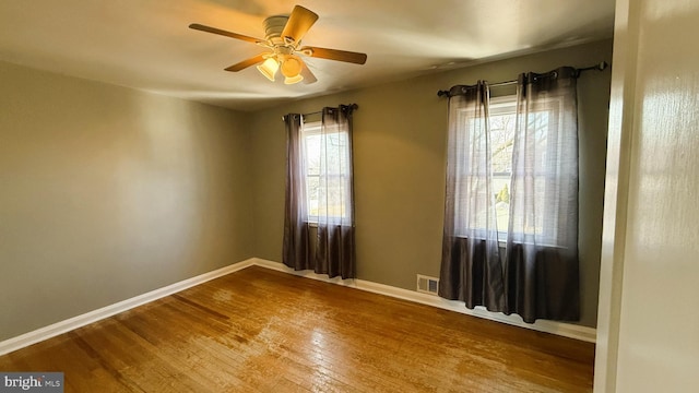 empty room featuring wood-type flooring and ceiling fan