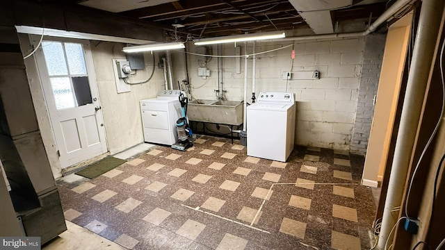 basement featuring sink and washing machine and dryer