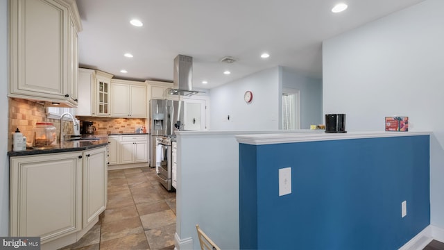 kitchen featuring sink, stainless steel appliances, cream cabinets, island range hood, and decorative backsplash