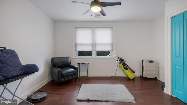 living area with dark wood-type flooring and ceiling fan