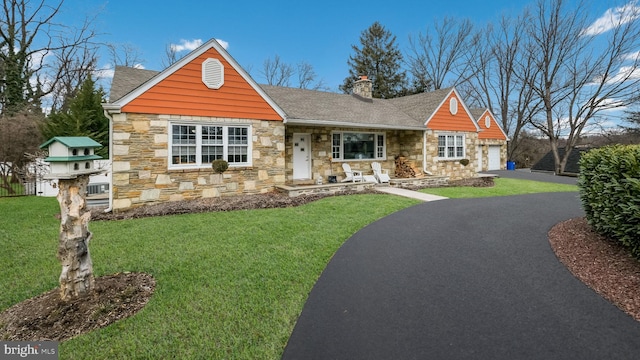 view of front of home featuring a garage and a front lawn