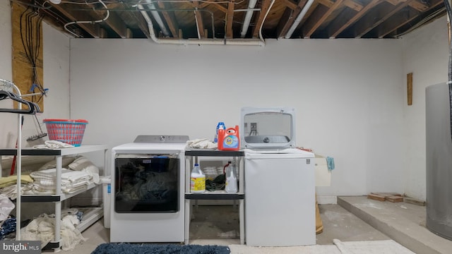 laundry area with water heater and washer and dryer