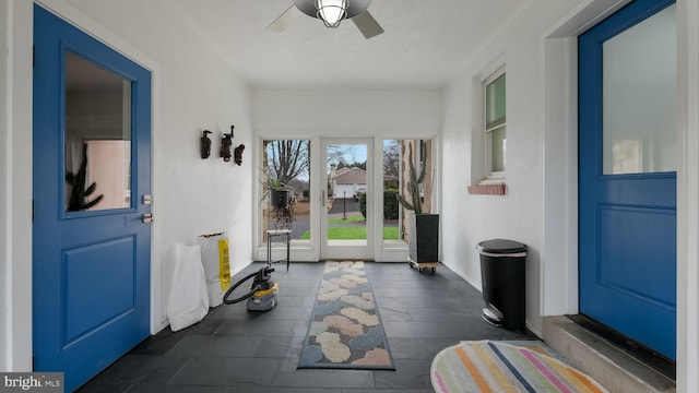 interior space with ceiling fan