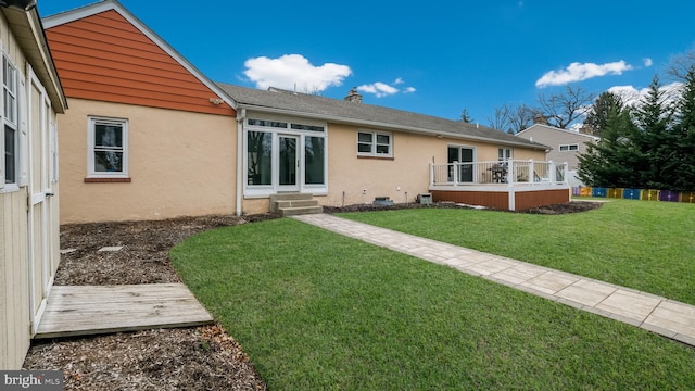 back of house with a lawn