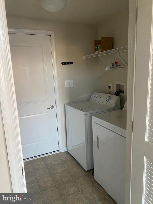 laundry area featuring tile patterned floors and separate washer and dryer