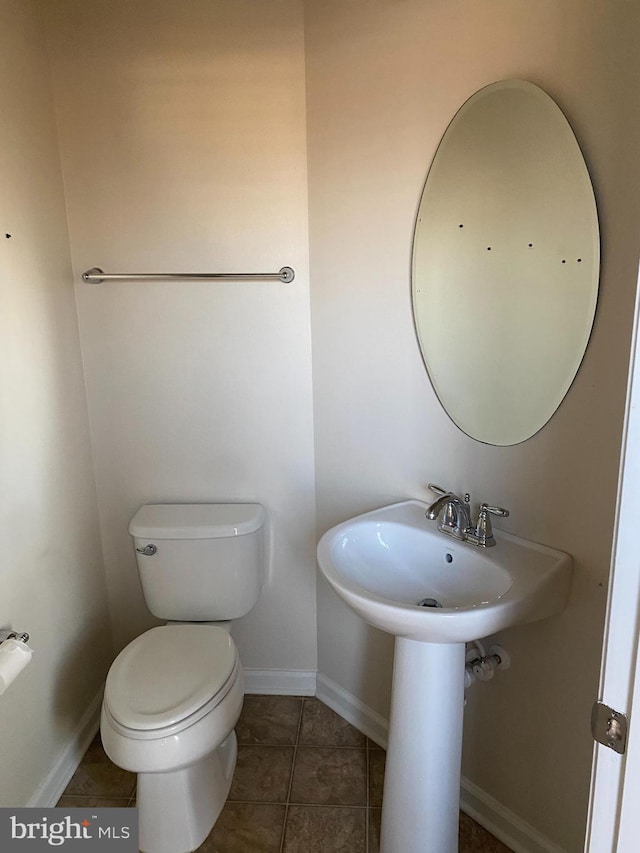 bathroom featuring tile patterned floors and toilet