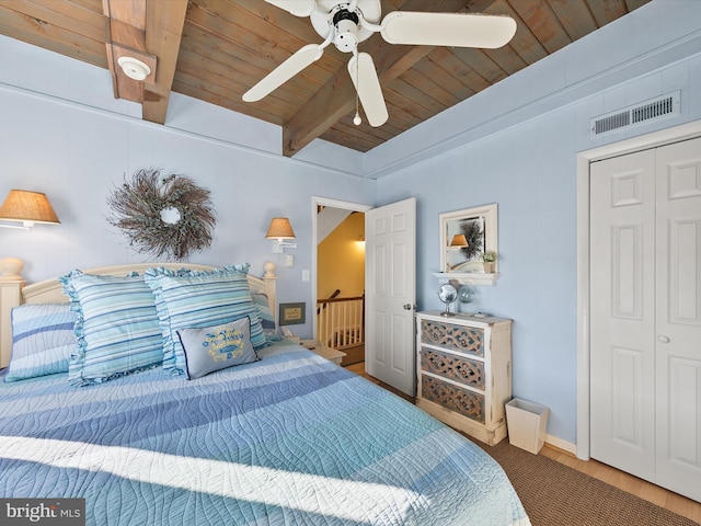 bedroom featuring ceiling fan, wood ceiling, and vaulted ceiling with beams