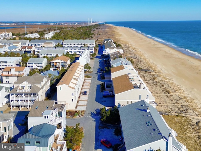 drone / aerial view featuring a water view and a beach view