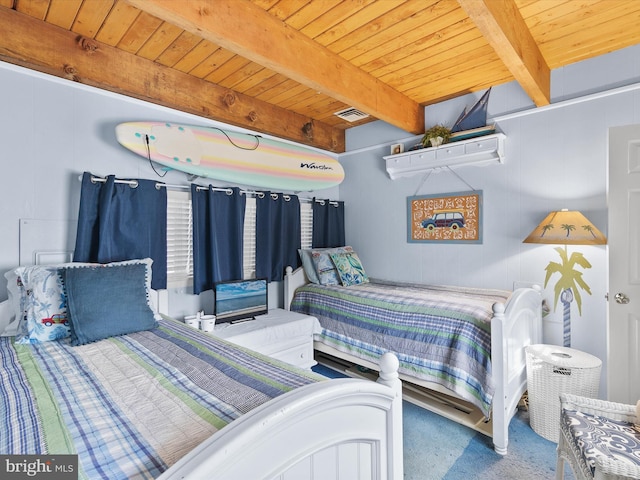 carpeted bedroom featuring beamed ceiling and wood ceiling