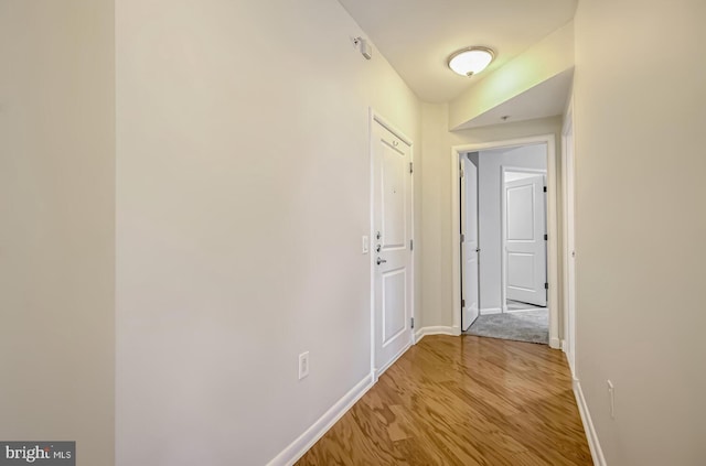 corridor with light wood-type flooring