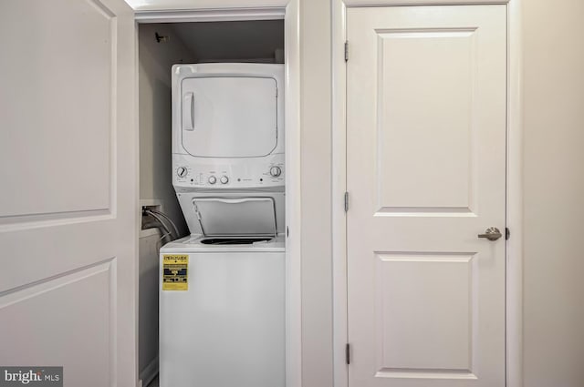 laundry area with stacked washing maching and dryer