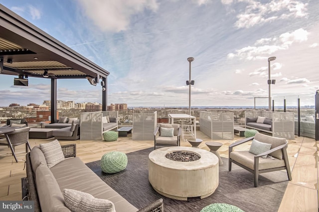 view of patio featuring an outdoor living space with a fire pit