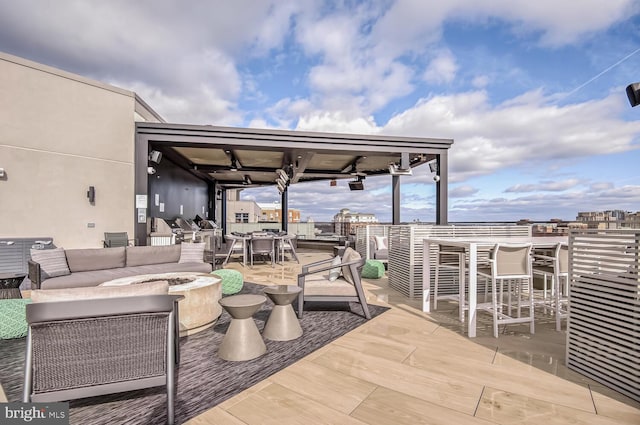 view of patio / terrace featuring an outdoor living space with a fire pit