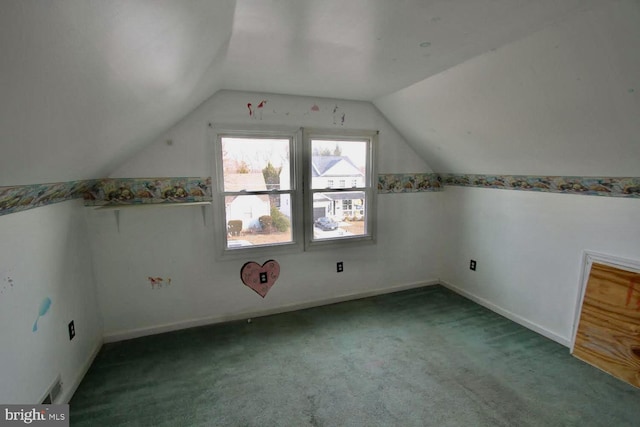 additional living space with vaulted ceiling and carpet flooring