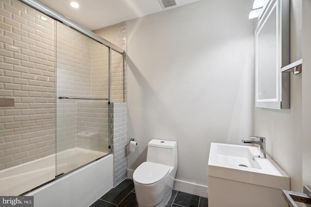 full bathroom with tile patterned flooring, enclosed tub / shower combo, vanity, and toilet