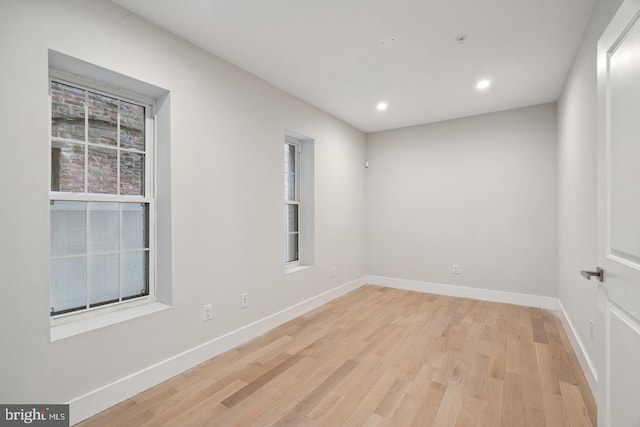 unfurnished room with light wood-type flooring