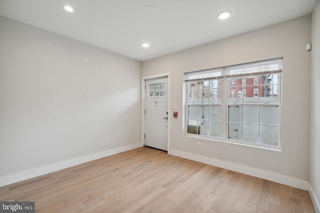 empty room with light hardwood / wood-style flooring