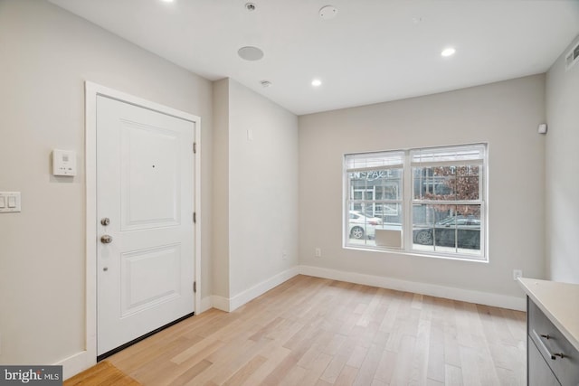 foyer entrance with light hardwood / wood-style flooring