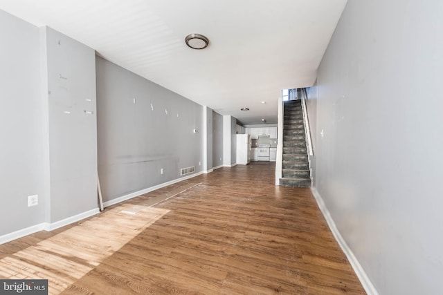 unfurnished living room featuring hardwood / wood-style flooring