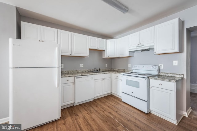 kitchen featuring sink, white appliances, hardwood / wood-style floors, light stone counters, and white cabinets