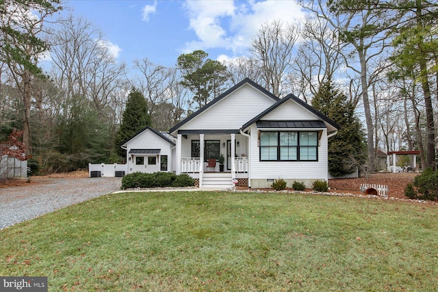 ranch-style home featuring a porch and a front lawn