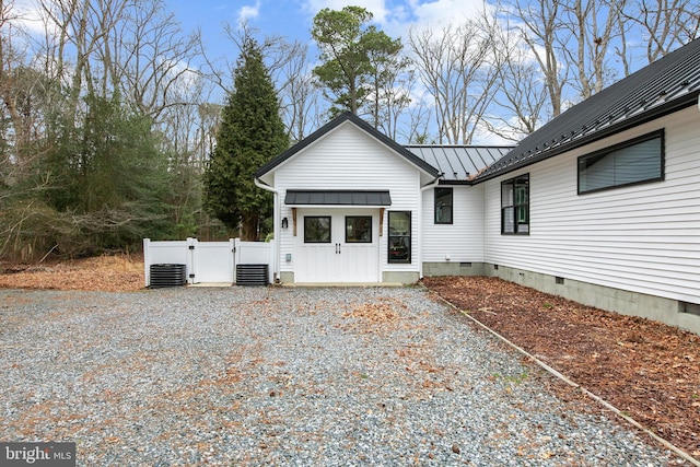 rear view of house featuring central AC