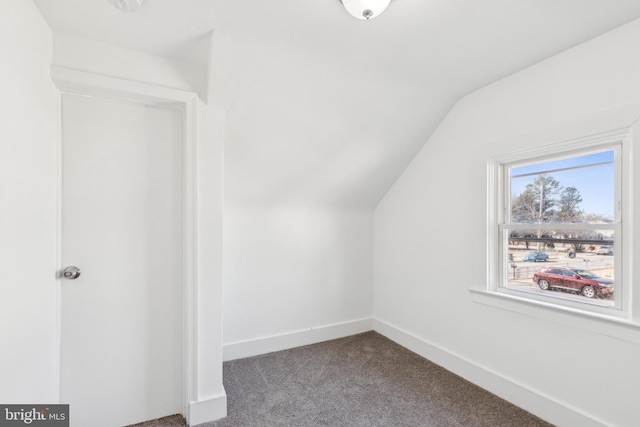 bonus room featuring vaulted ceiling, carpet flooring, and baseboards