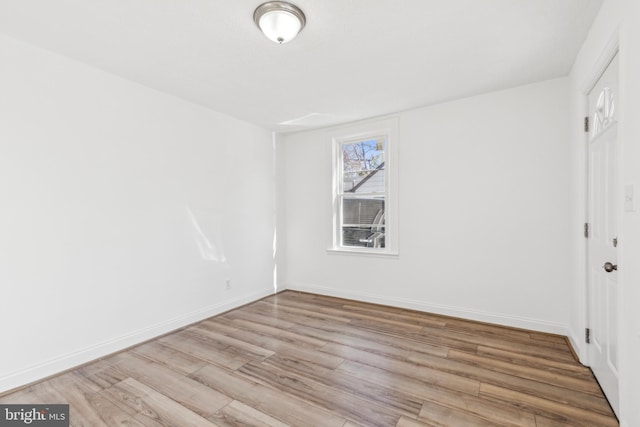 unfurnished bedroom featuring light wood-style flooring and baseboards