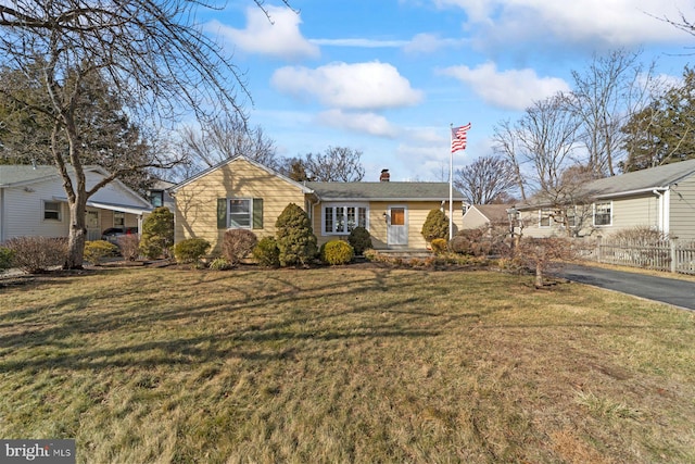 ranch-style home with a front lawn