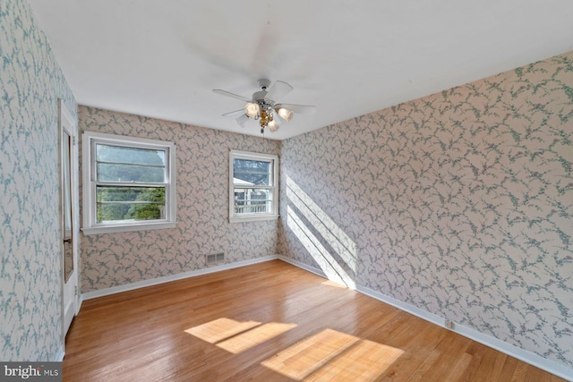 spare room featuring hardwood / wood-style flooring and ceiling fan