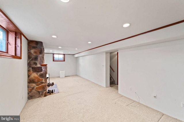 basement featuring light carpet