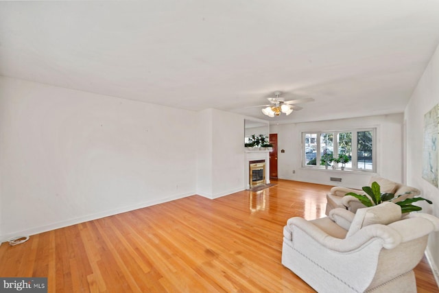 living room with ceiling fan and light hardwood / wood-style flooring