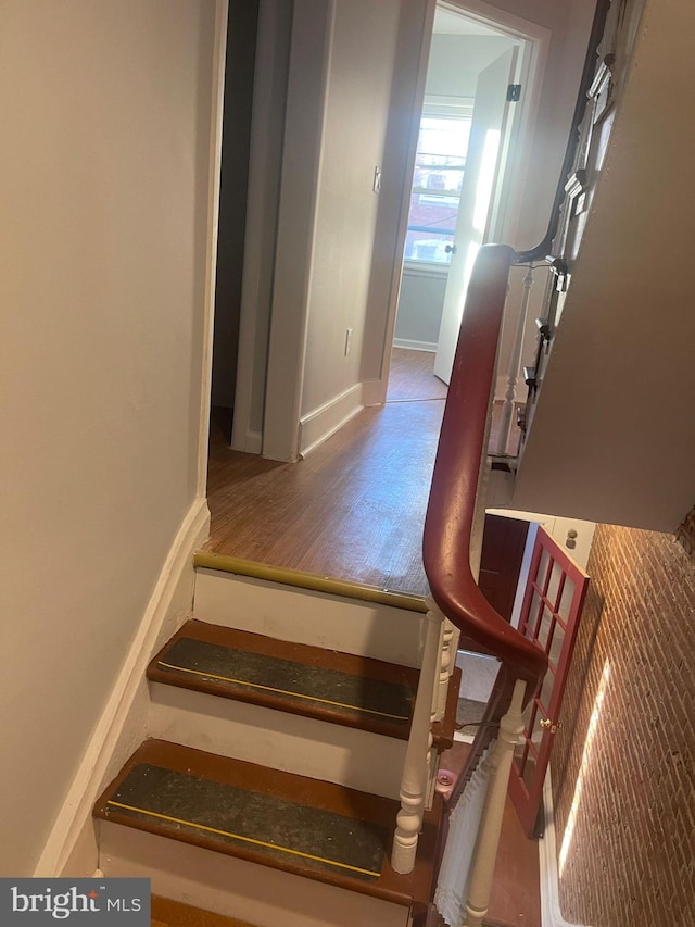 staircase featuring hardwood / wood-style floors