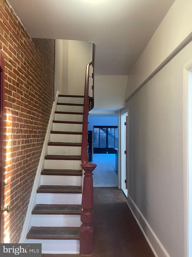 staircase with brick wall