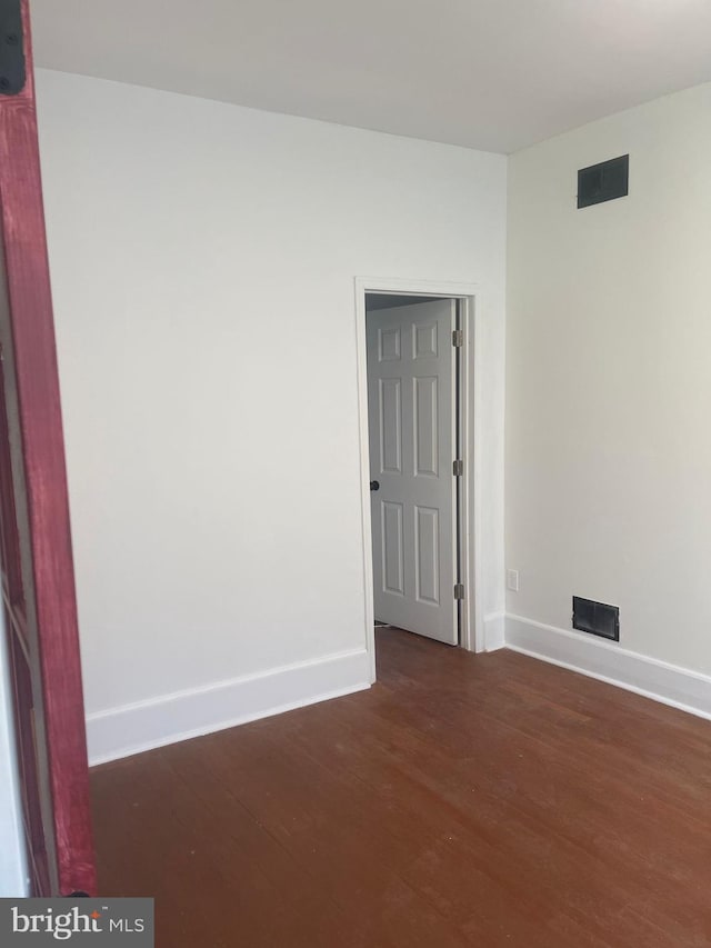 unfurnished room with dark hardwood / wood-style floors