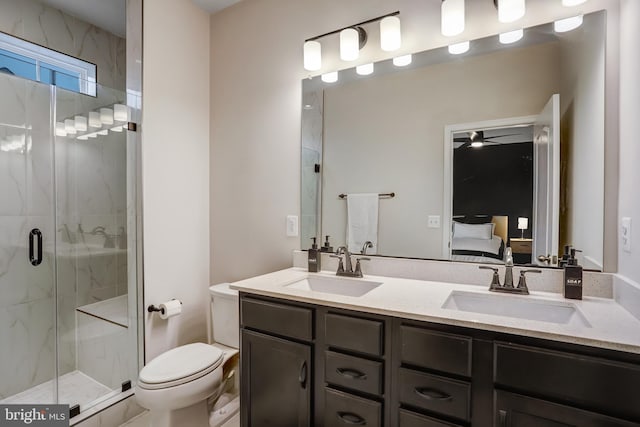 bathroom featuring vanity, an enclosed shower, ceiling fan, and toilet