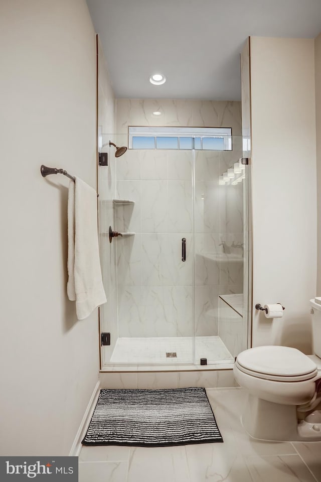 bathroom featuring toilet and walk in shower