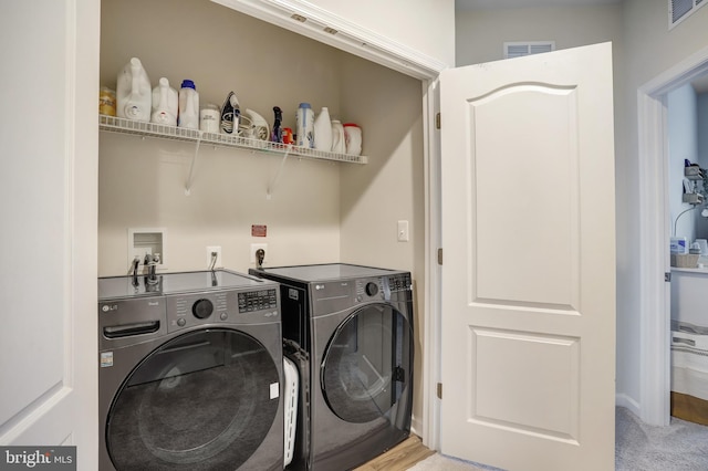 laundry room with washing machine and clothes dryer