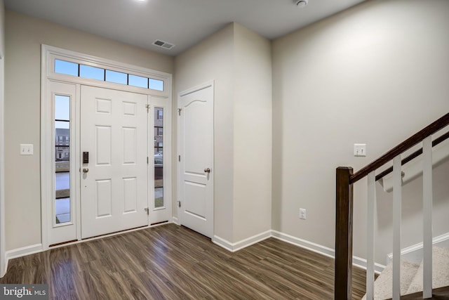 foyer entrance with dark hardwood / wood-style floors