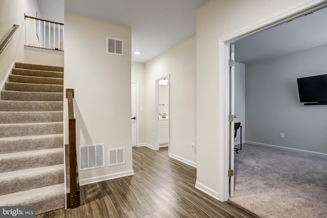 stairs with hardwood / wood-style floors