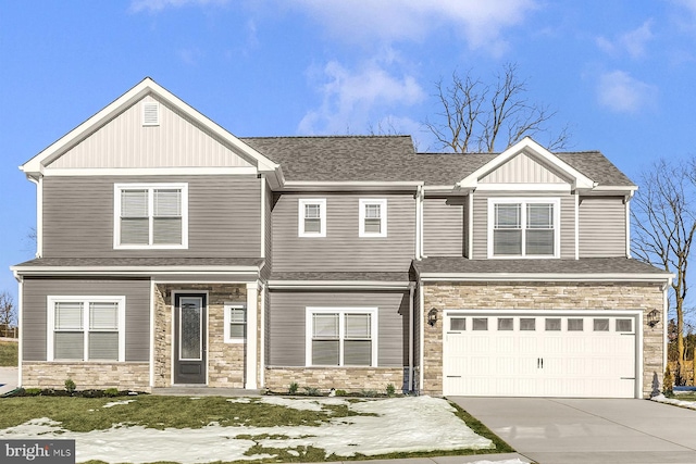 view of front facade featuring driveway, stone siding, an attached garage, and roof with shingles