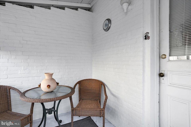 living area with brick wall