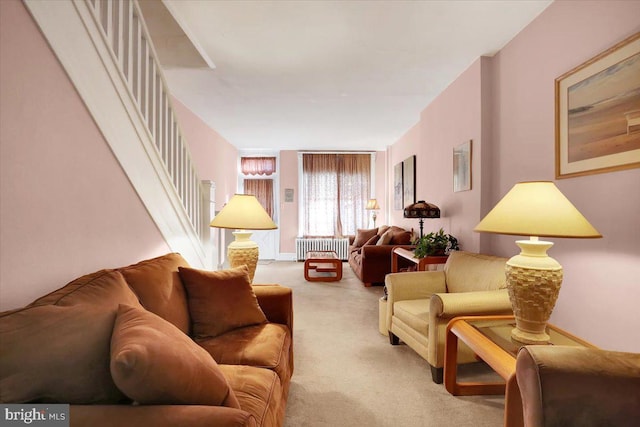 living room with radiator and light carpet