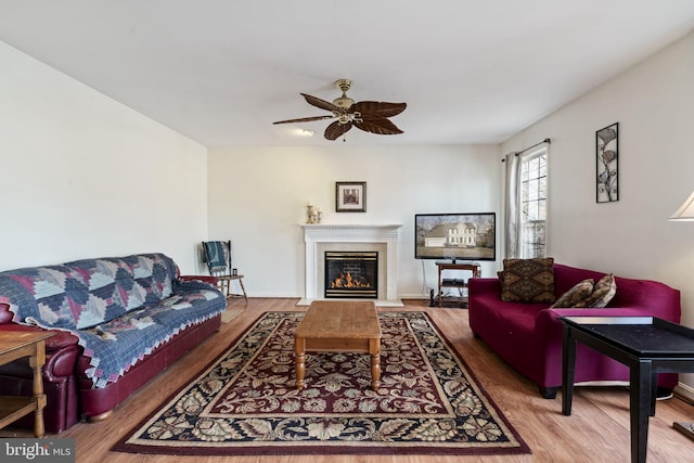 living room with hardwood / wood-style floors and ceiling fan