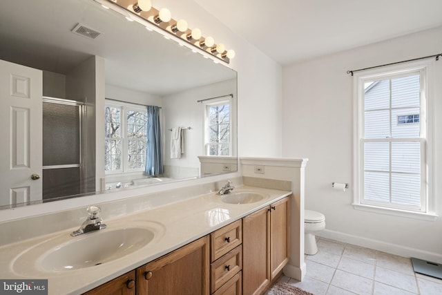 bathroom with vanity, a shower with shower door, tile patterned floors, and toilet