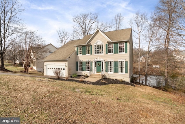 colonial-style house with a garage and a front yard