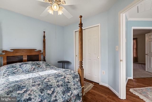 bedroom with dark hardwood / wood-style flooring, crown molding, and ceiling fan