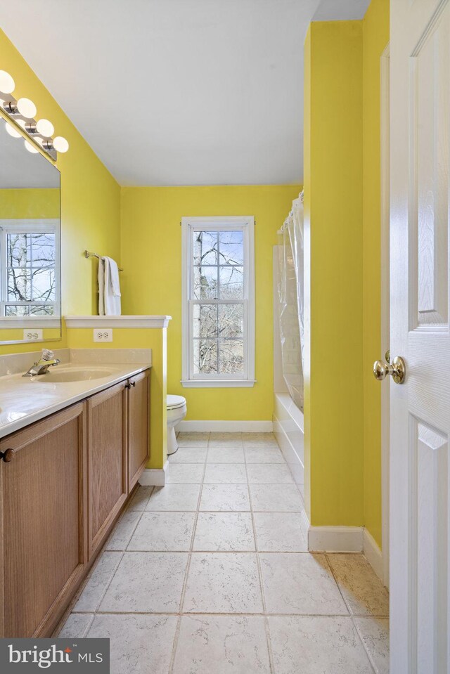 full bathroom featuring vanity, tile patterned flooring, shower / bath combo, and toilet