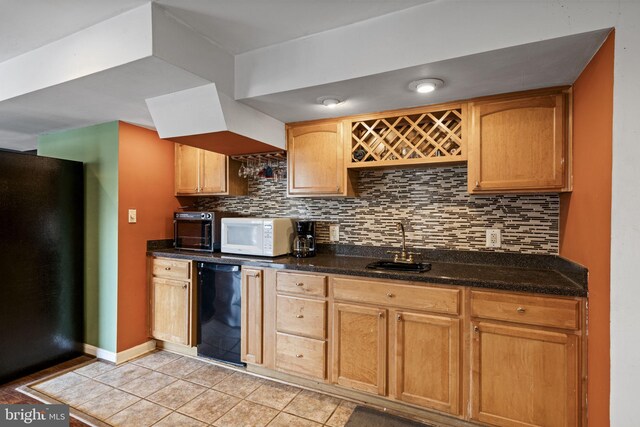 kitchen featuring tasteful backsplash, sink, light tile patterned floors, and dark stone counters